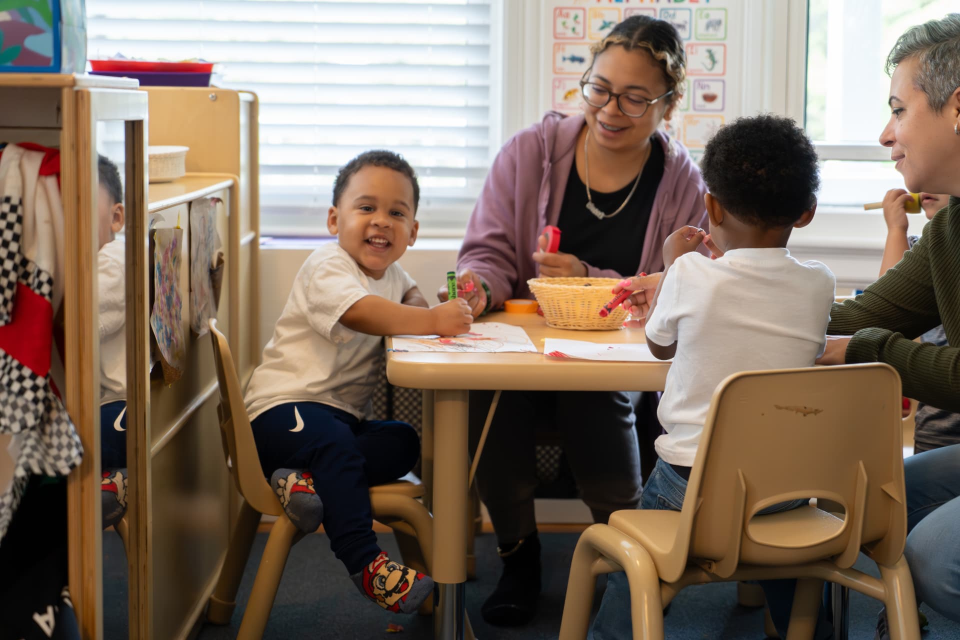 TEAM educators and young children creating together around a classroom table