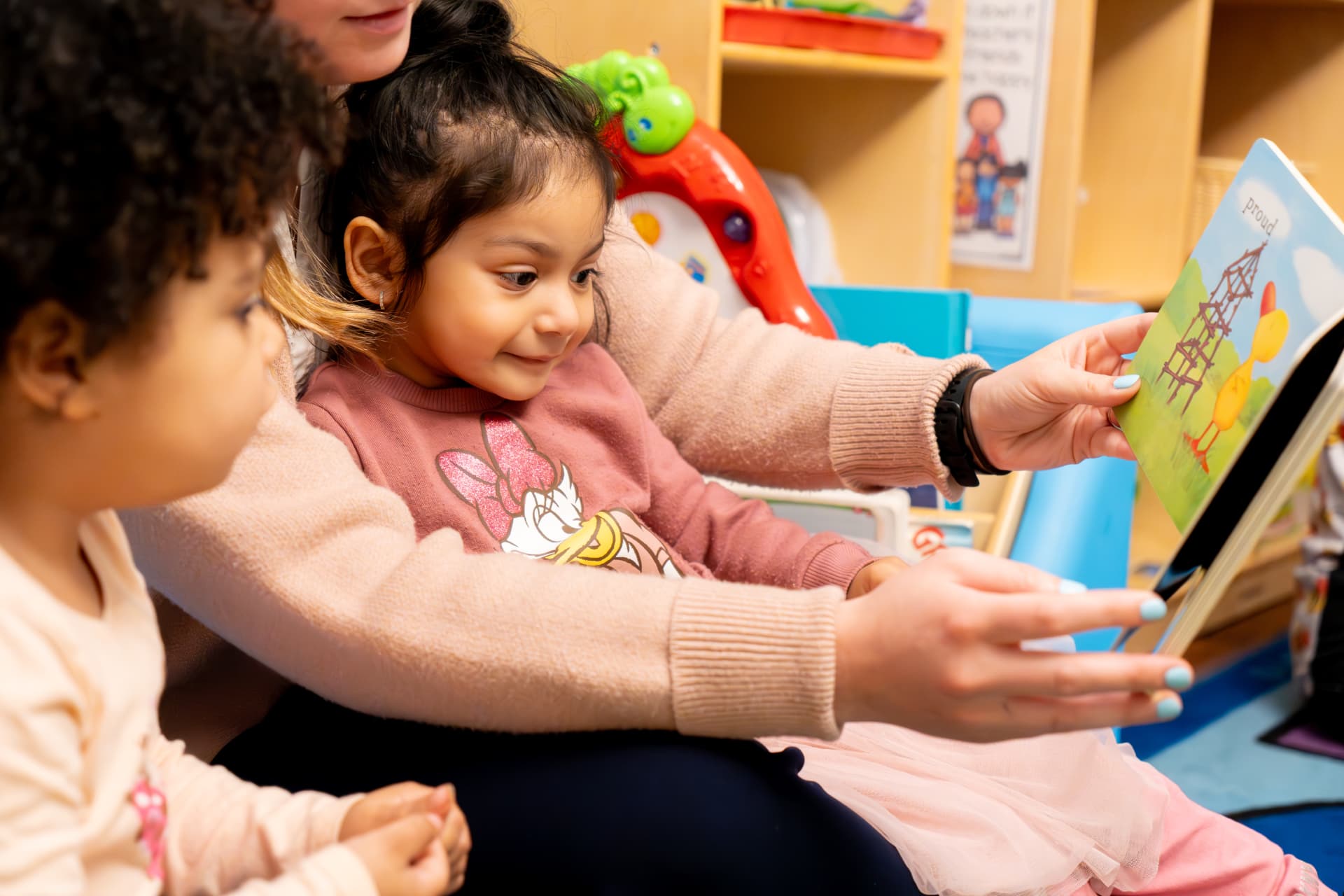 A TEAM educator reading with young children