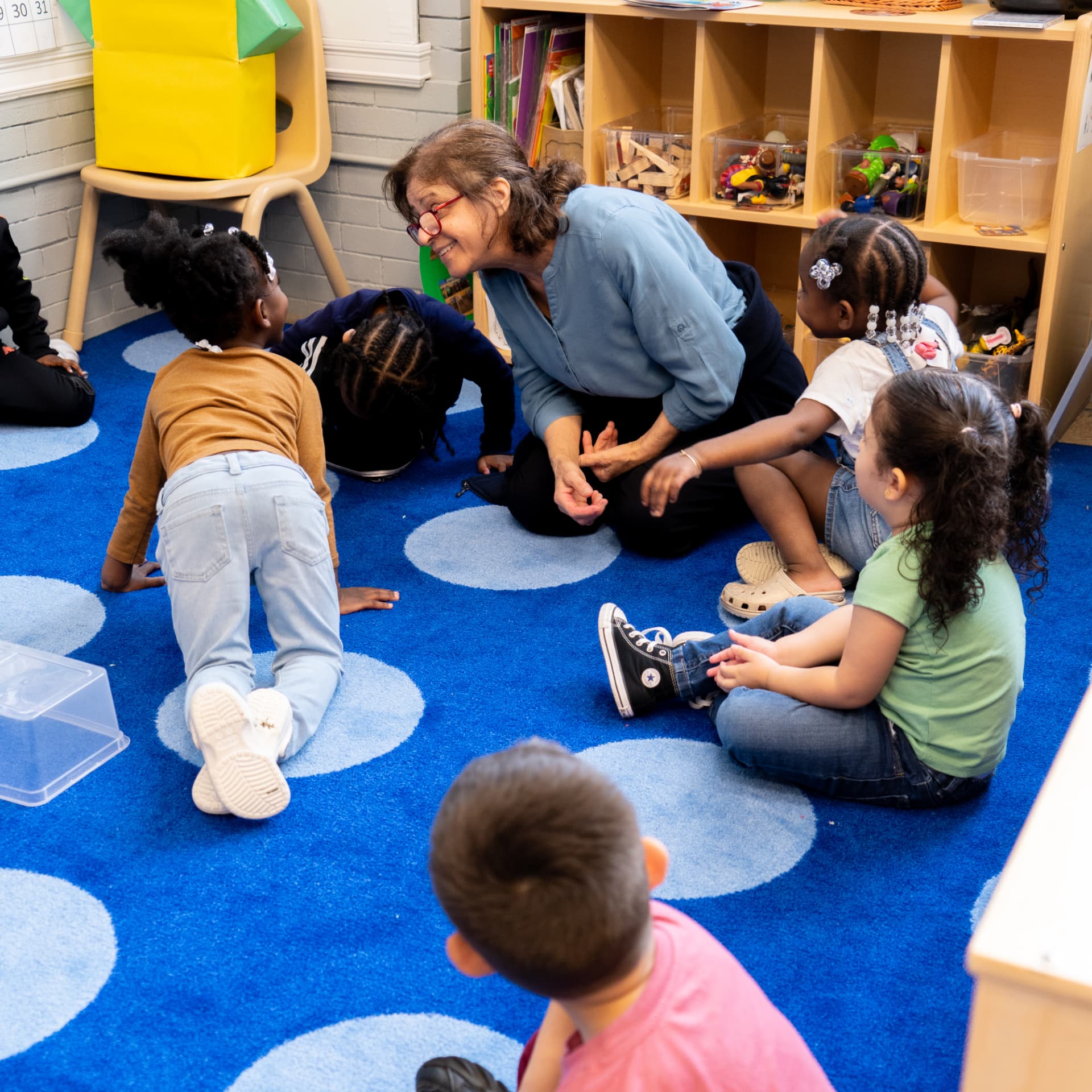 A TEAM educator connecting with children during classroom circle time
