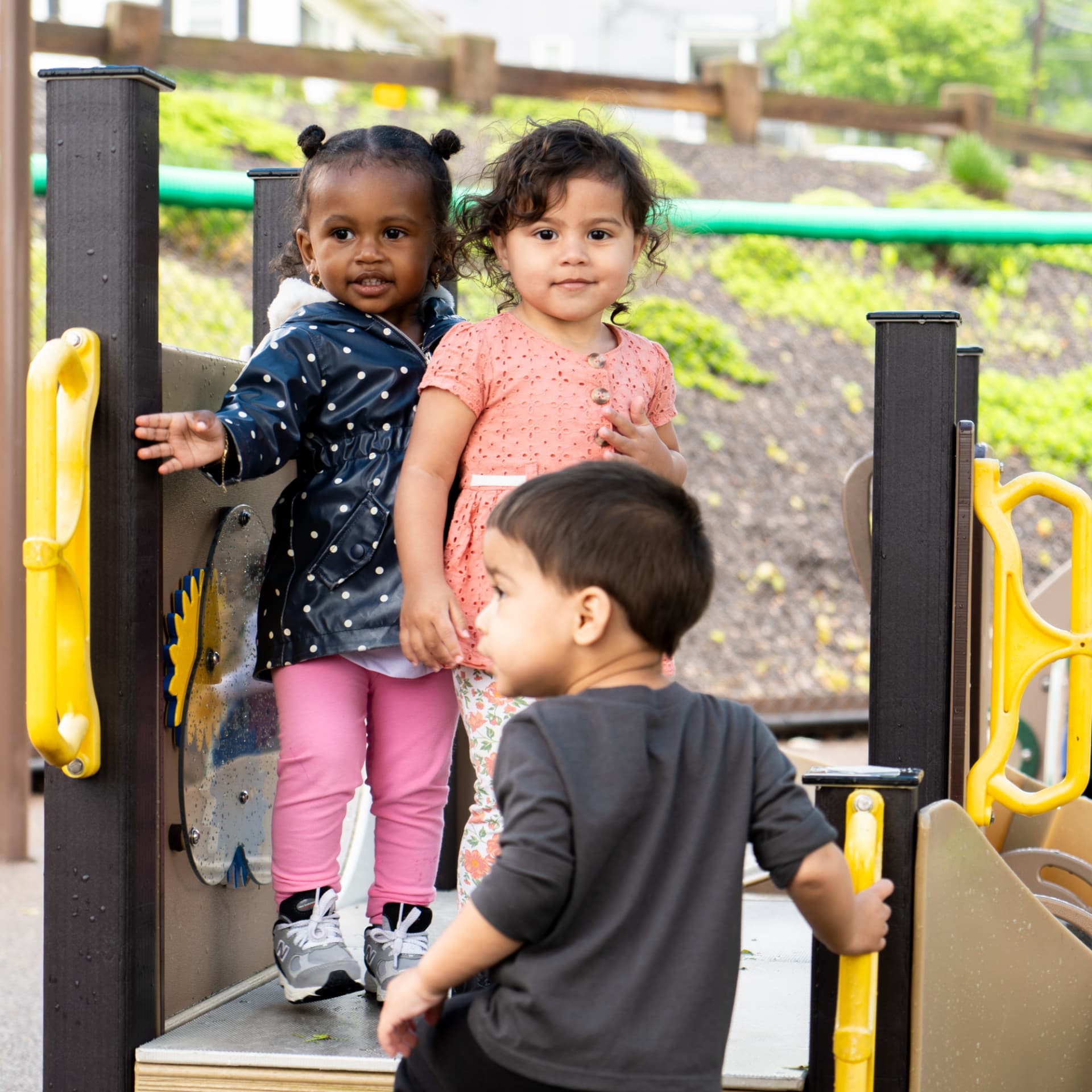 Young children playing together on the TEAM playground